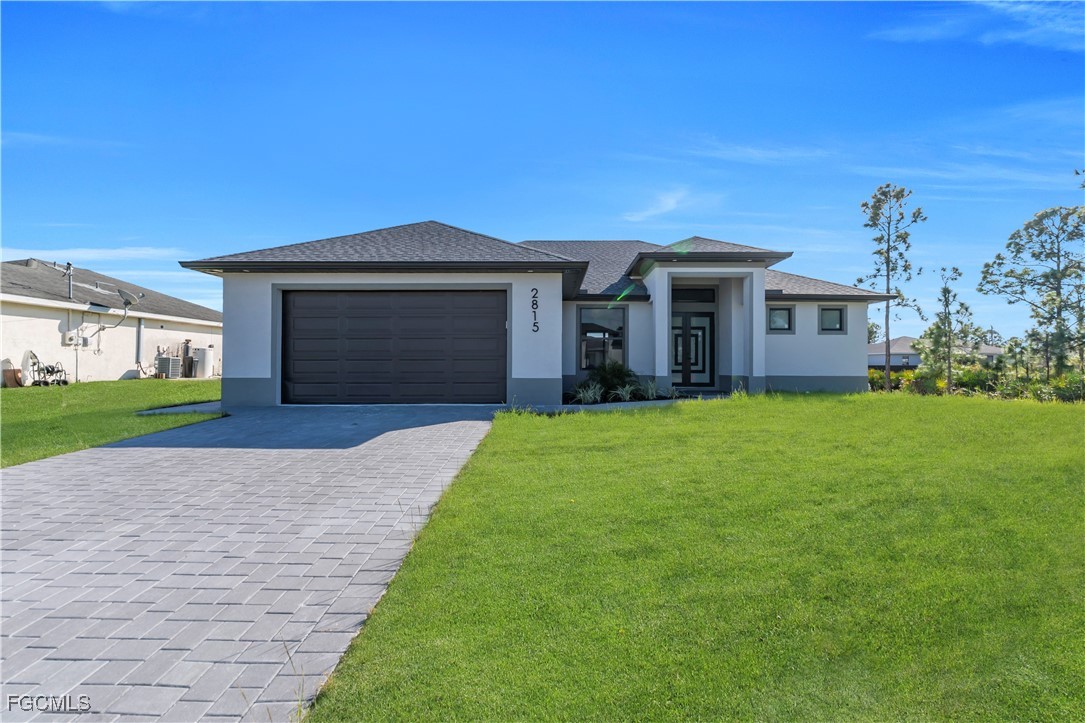 a front view of a house with a yard and garage