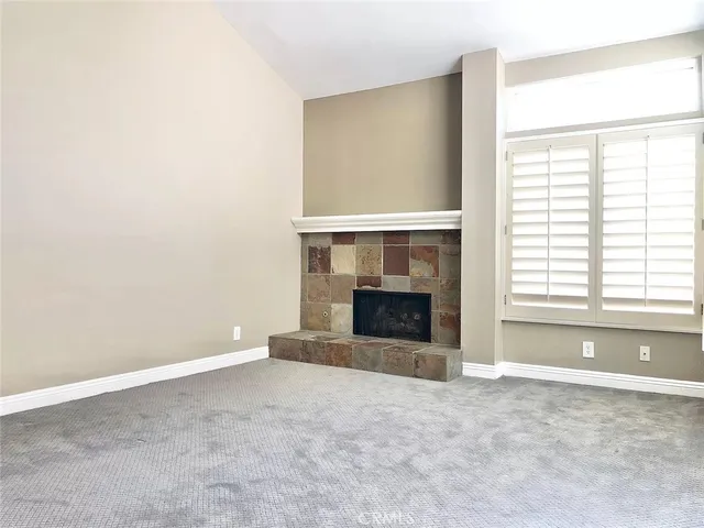 a view of an empty room with kitchen