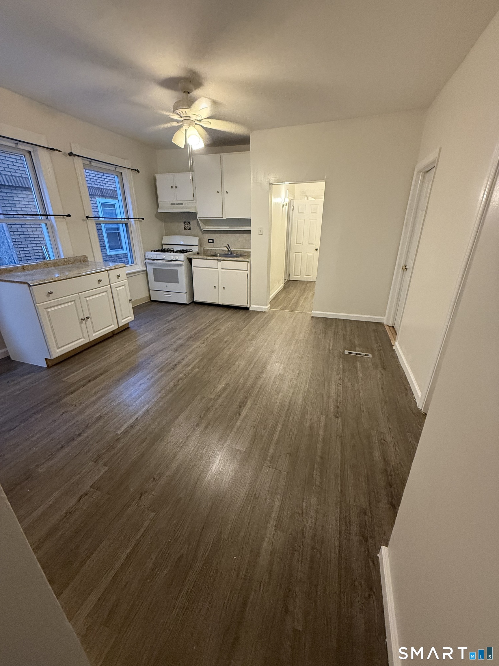 180 5th Street, Unit 1 Bridgeport, CT 06607 - Photo 13 of 26 a view of a kitchen from the hallway