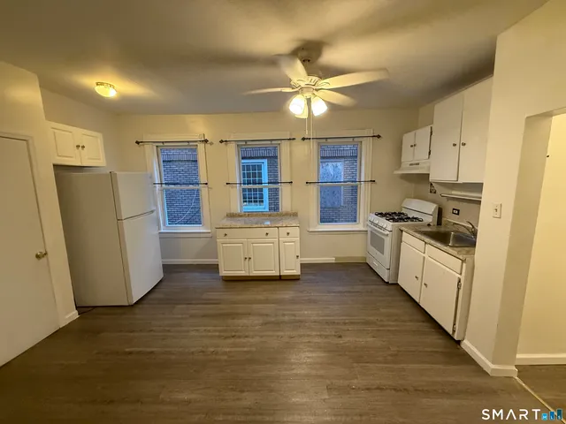 a kitchen with stainless steel appliances a refrigerator sink and cabinets