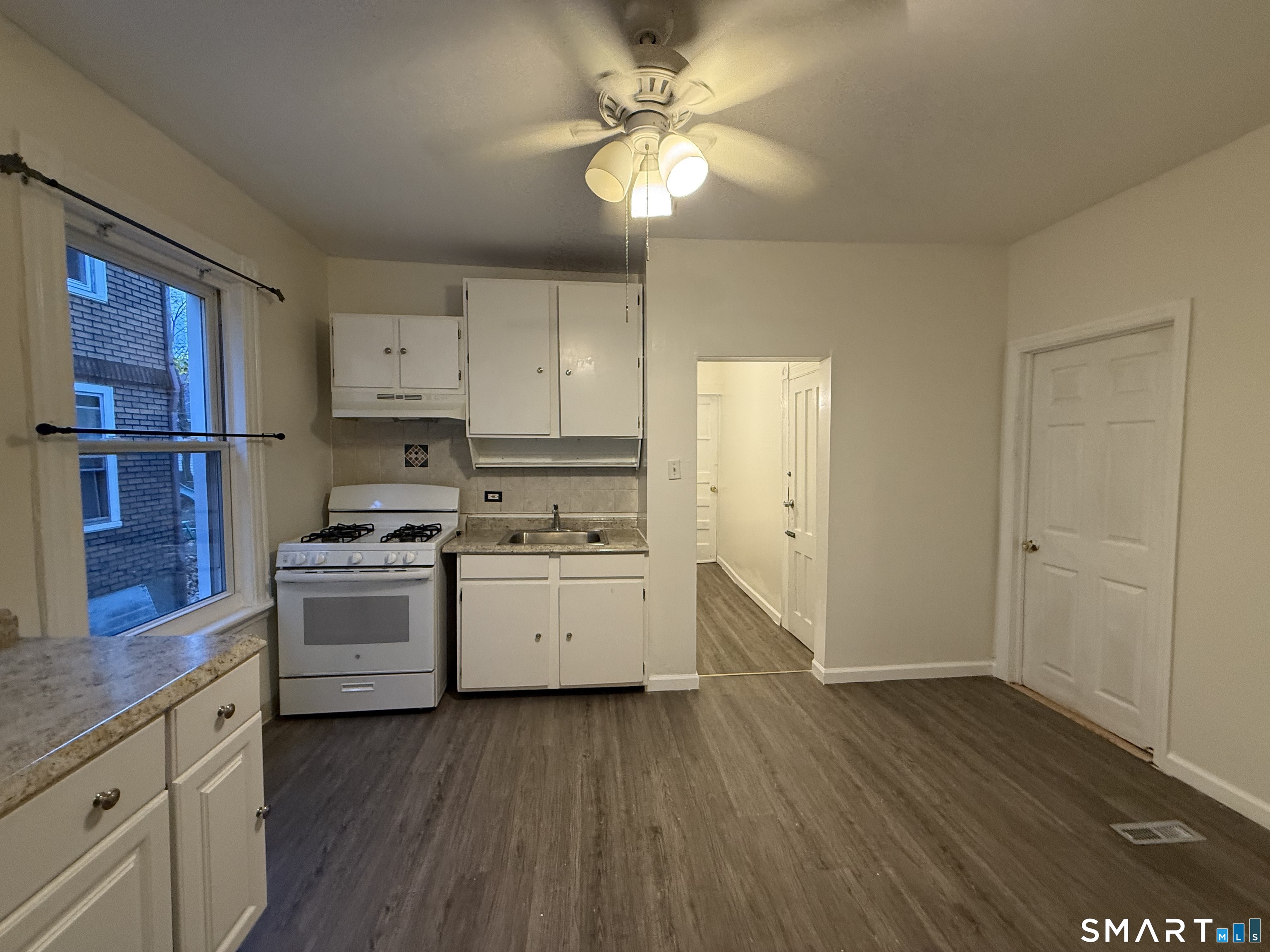 180 5th Street, Unit 1 Bridgeport, CT 06607 - Photo 19 of 26 a kitchen with a stove a sink and a refrigerator