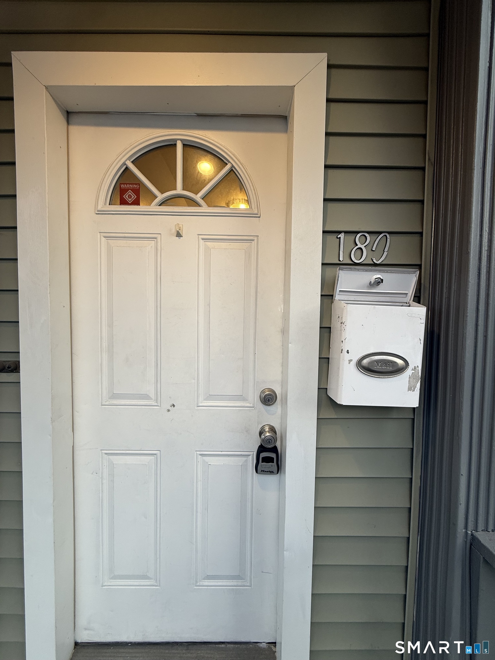 180 5th Street, Unit 1 Bridgeport, CT 06607 - Photo 2 of 26 a front view of a house with a door and a wooden floor