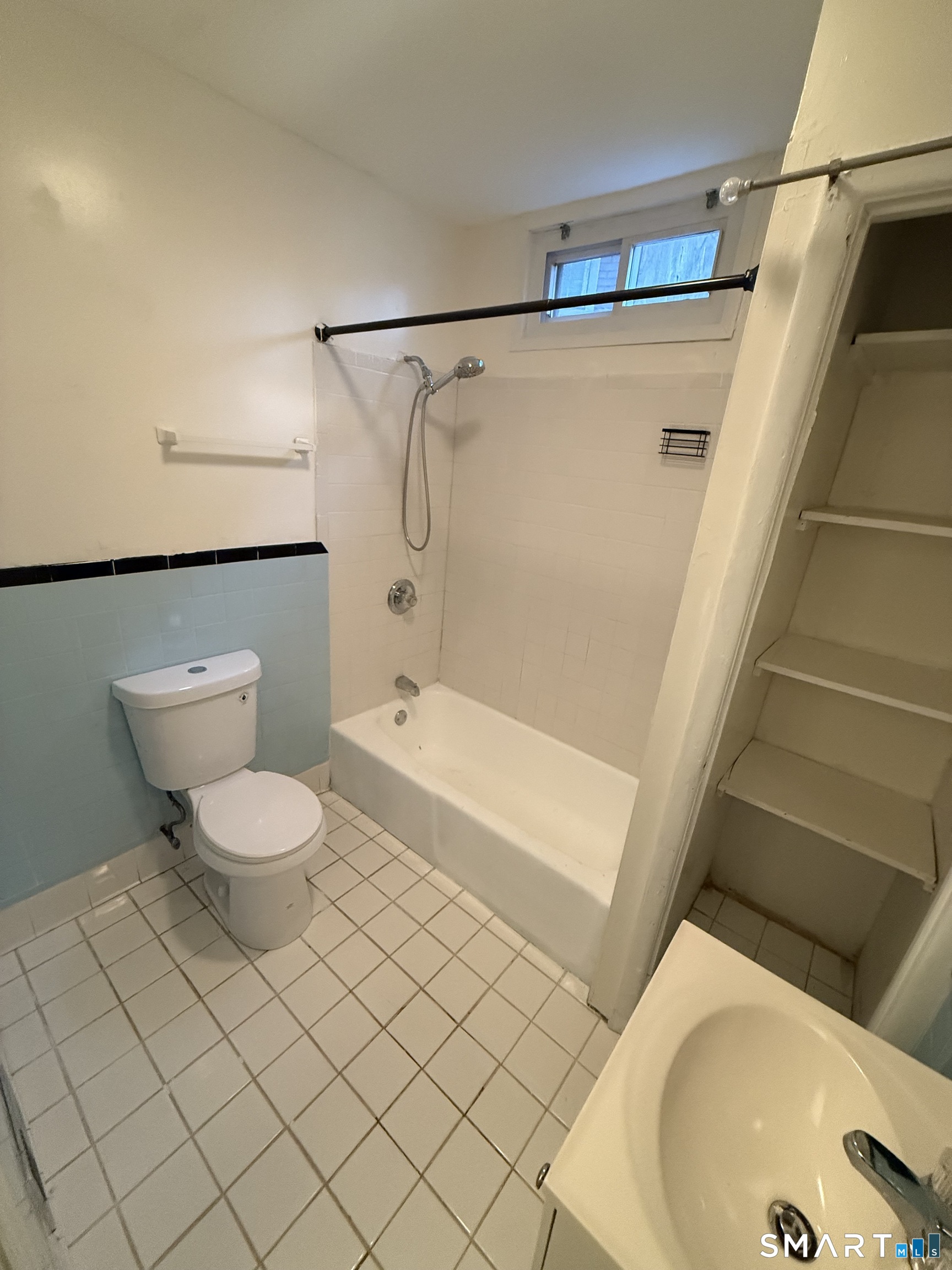 180 5th Street, Unit 1 Bridgeport, CT 06607 - Photo 24 of 26 a bathroom with a toilet and a shower