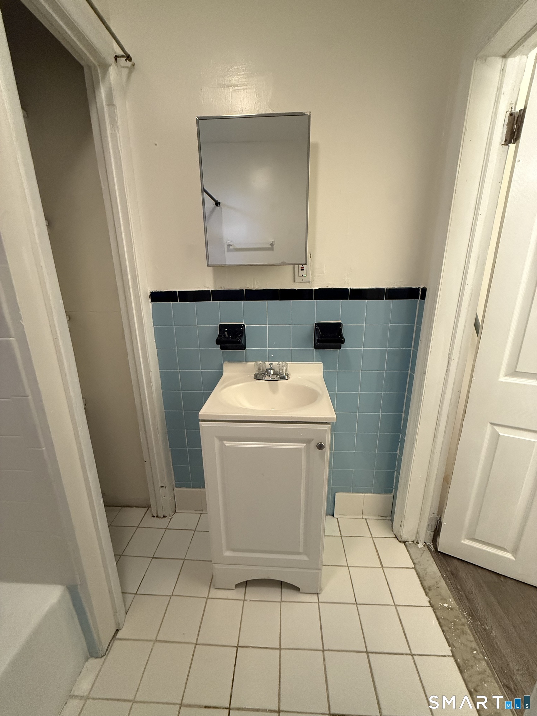 180 5th Street, Unit 1 Bridgeport, CT 06607 - Photo 26 of 26 a bathroom with a sink a toilet and a mirror