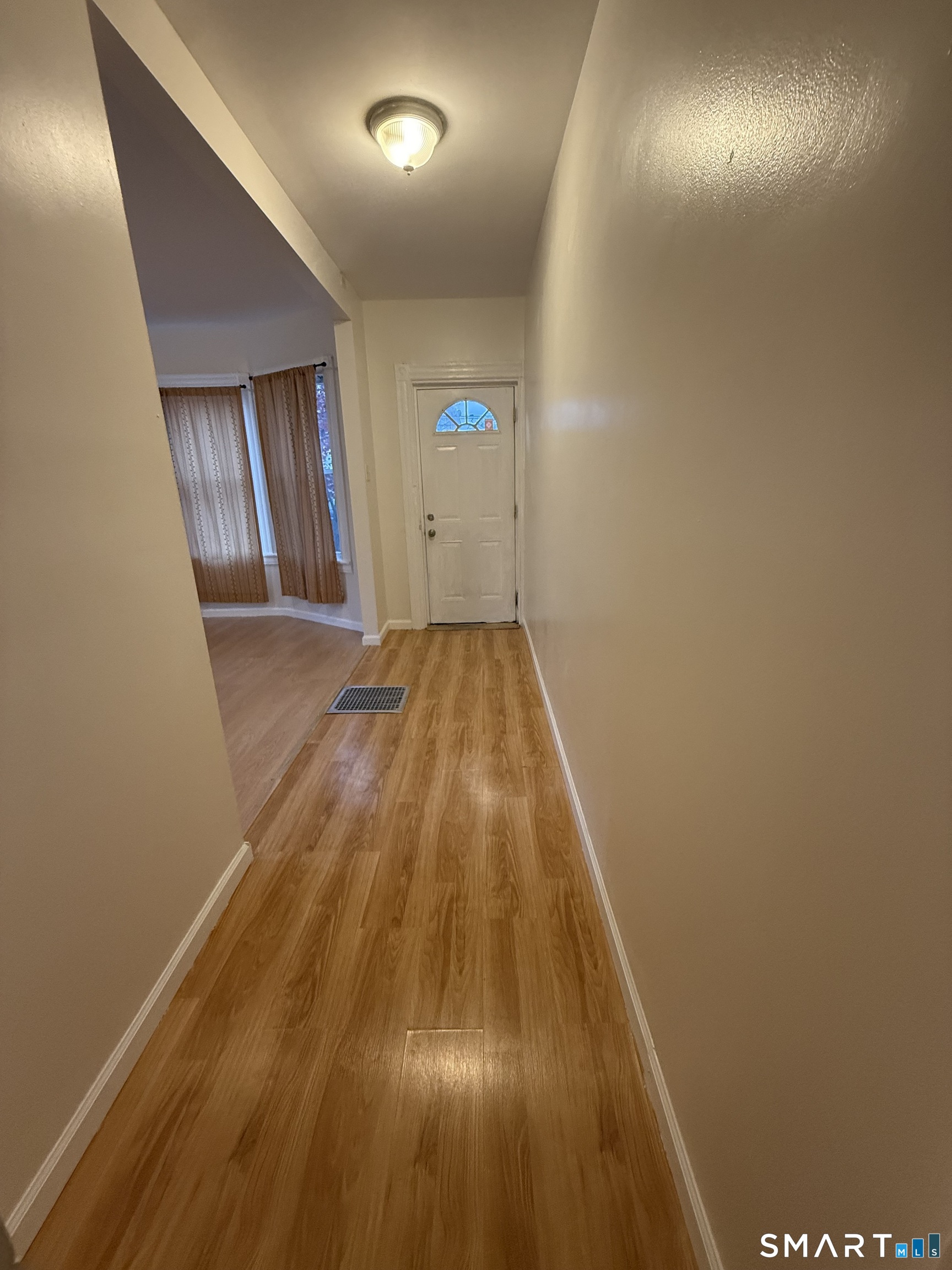 180 5th Street, Unit 1 Bridgeport, CT 06607 - Photo 4 of 26 wooden floor in an empty room with wooden floor