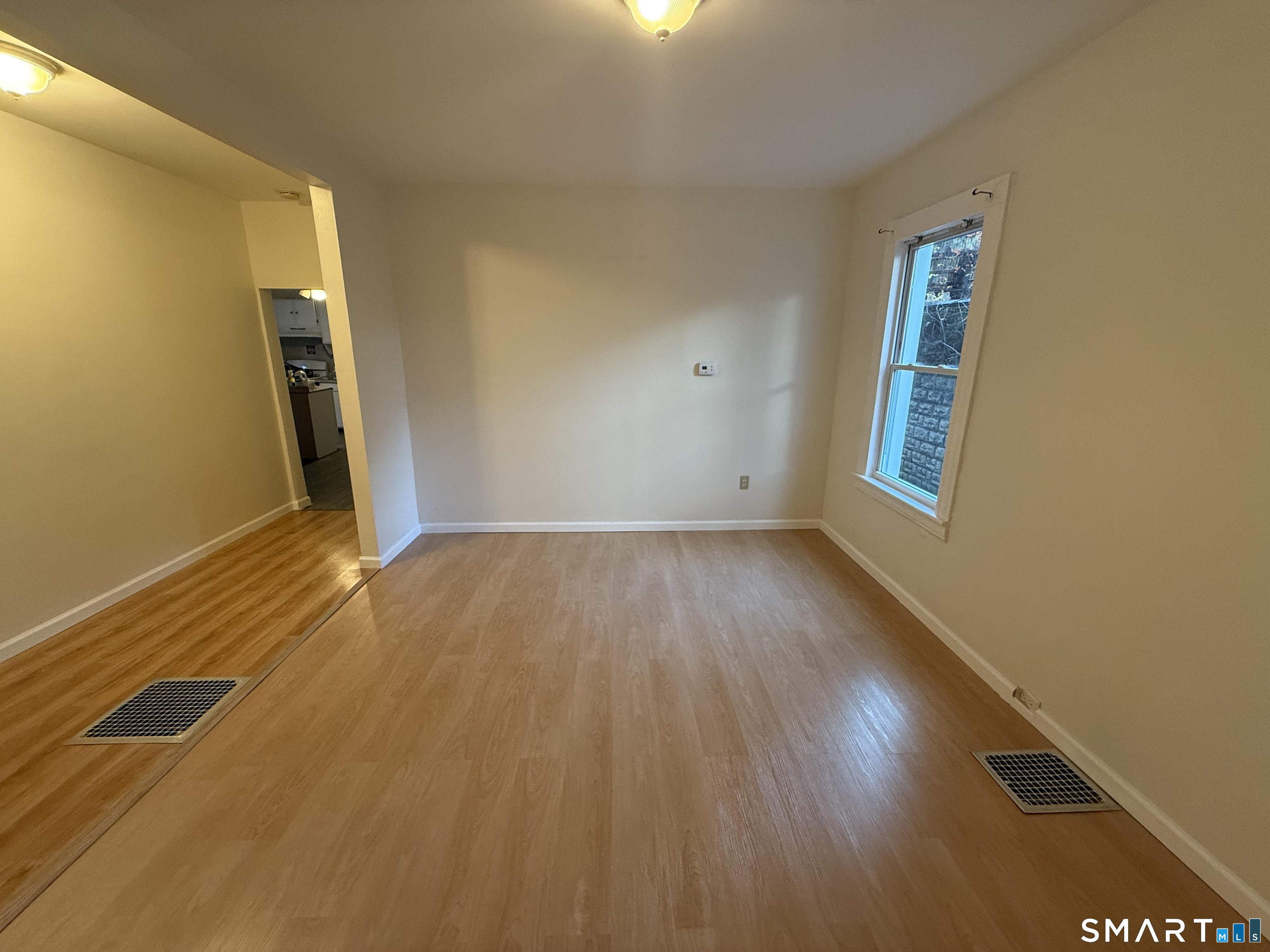 180 5th Street, Unit 1 Bridgeport, CT 06607 - Photo 6 of 26 a view of a room with wooden floor and a window