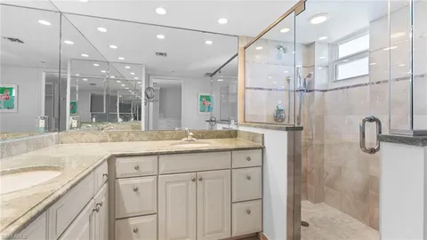 a bathroom with a granite countertop sink mirror and double