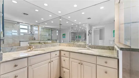 a bathroom with a double vanity sink and a mirror