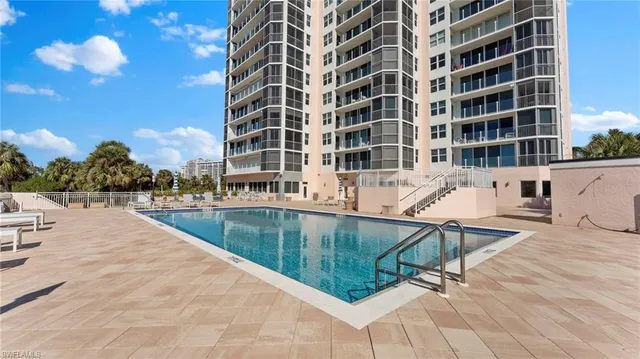 a swimming pool with outdoor seating and yard