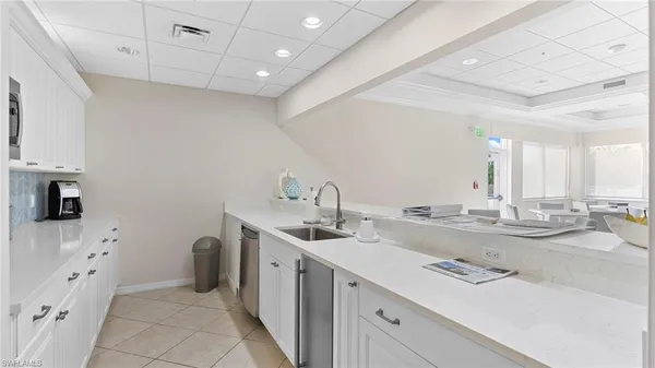 a kitchen with sink stove and cabinets