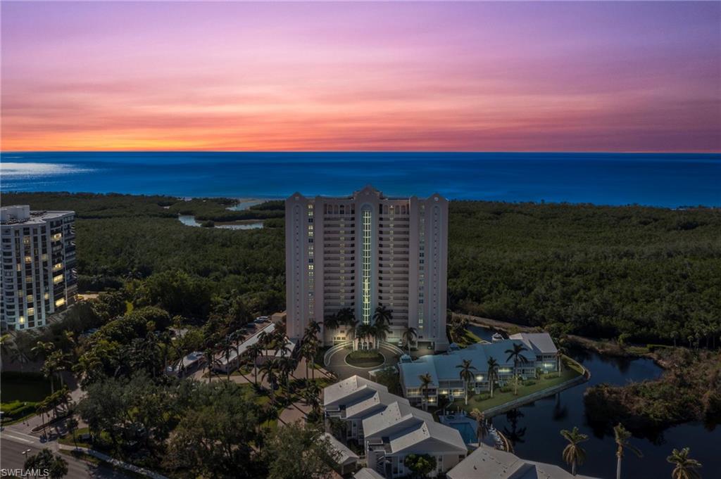 6101 Pelican Bay Boulevard, Unit 1404 Naples, FL 34108 - Photo 22 of 22 a view of a city with sunset view