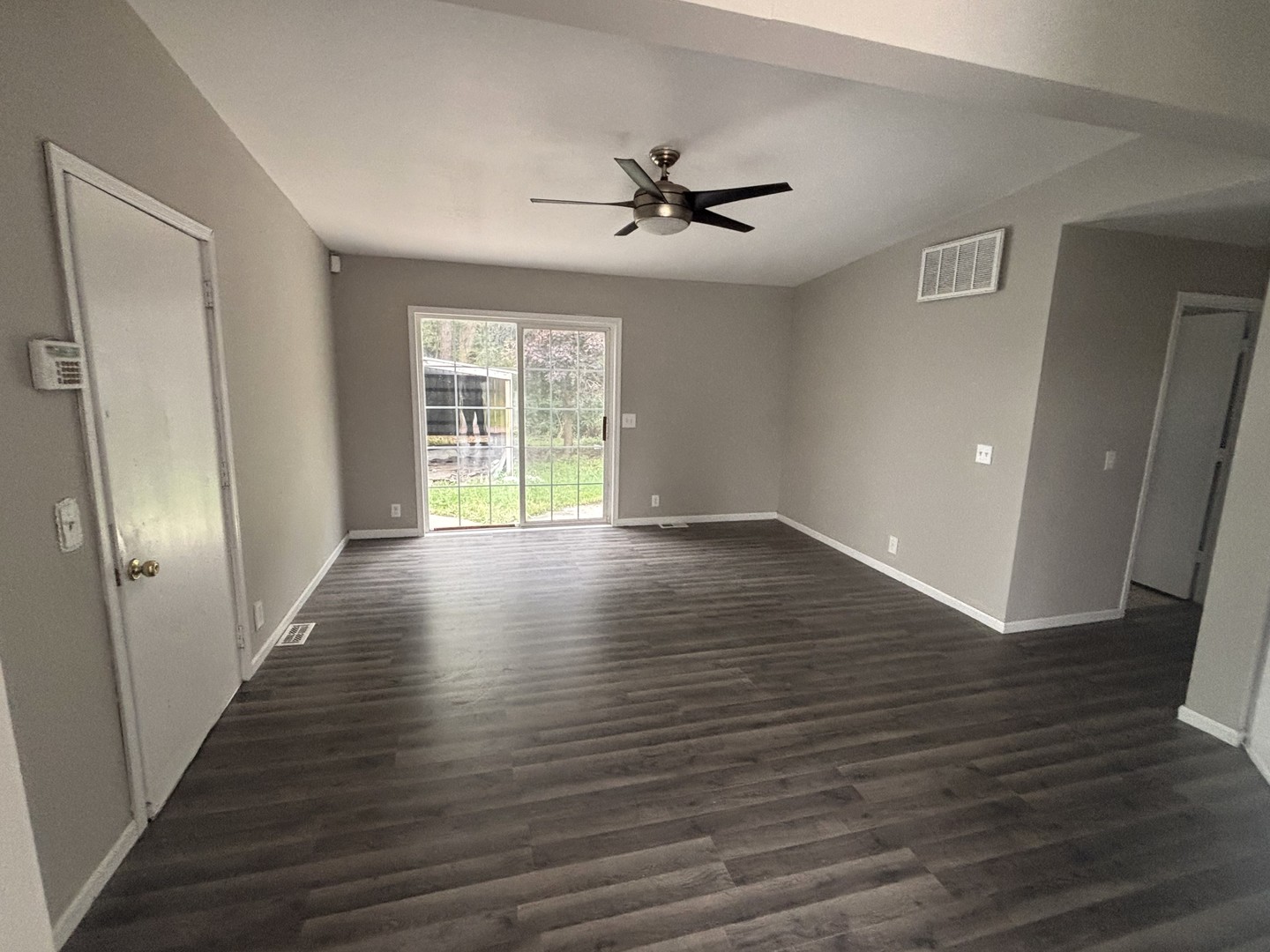 37150 South Macks Road Wilmington, IL 60481 - Photo 6 of 20 a view of an empty room with wooden floor and a window