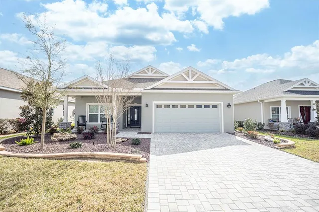 a view of a house with swimming pool and sitting area
