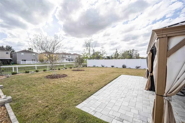 a view of yard with swimming pool and sitting area
