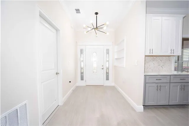 a view of a kitchen with wooden cabinet