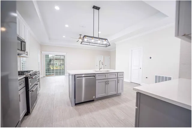 a kitchen with stainless steel appliances granite countertop a sink stove and refrigerator