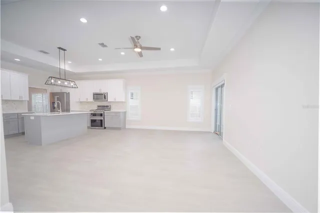 a view of a kitchen with furniture and windows