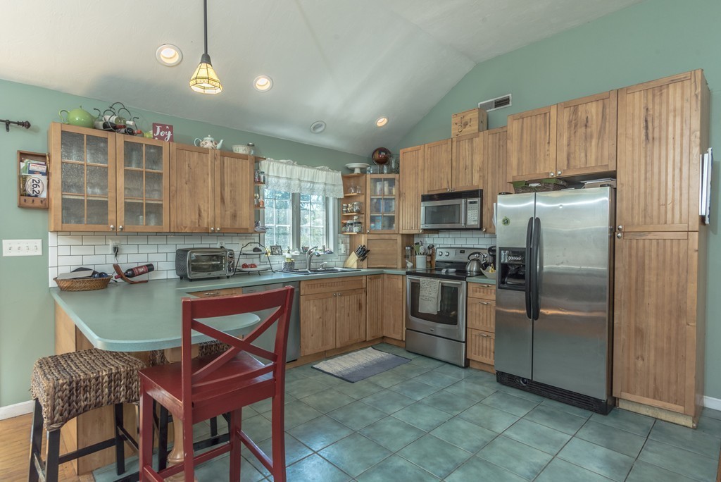 6 Pearl Road Billerica, MA 01821 - Photo 9 of 29 a kitchen with cabinets and stainless steel appliances