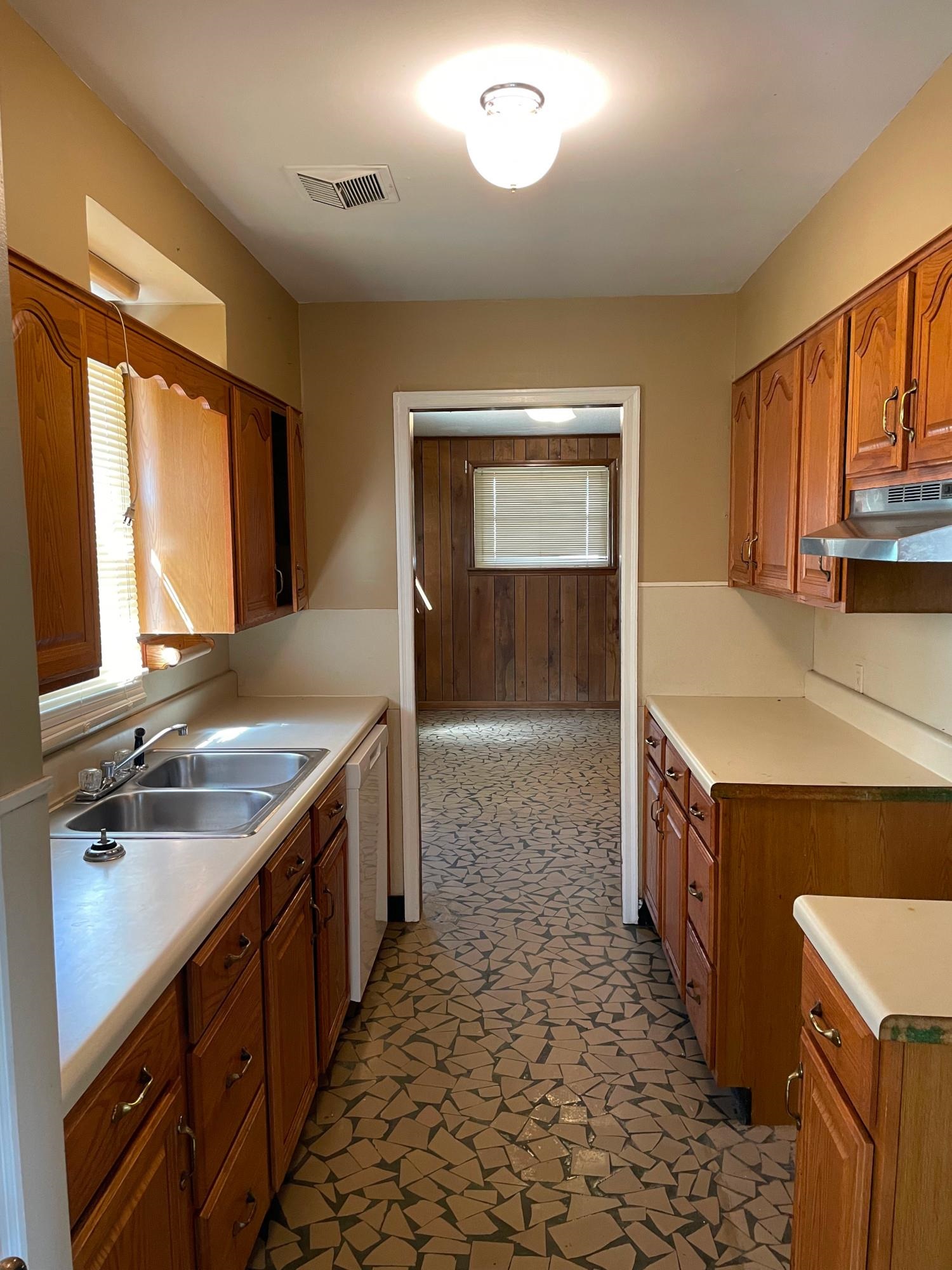 4394 Daytona Road Memphis, TN 38108 - Photo 6 of 14 a kitchen with a sink stove and cabinets