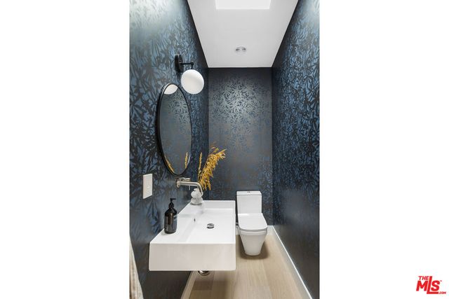 a bathroom with a toilet and a mirror