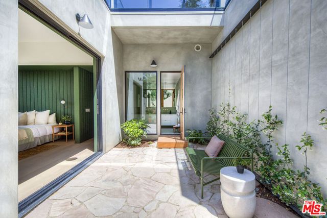 a house with potted plants in front of door