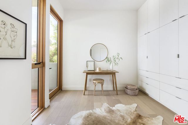 a view of a room that has a bed and a table in it