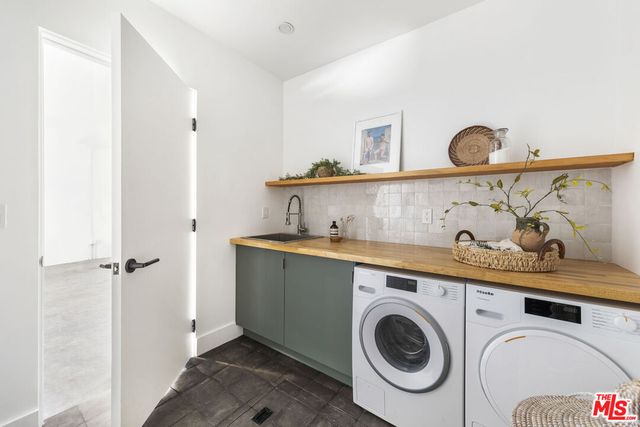 a view of a kitchen with sink and washing machine