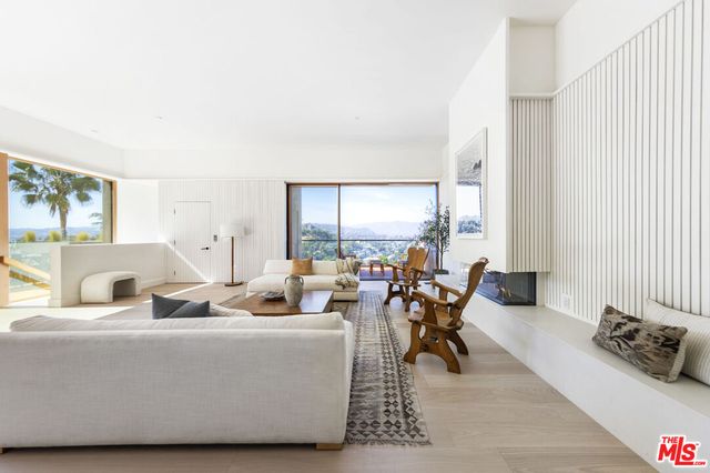 a living room with furniture and large windows