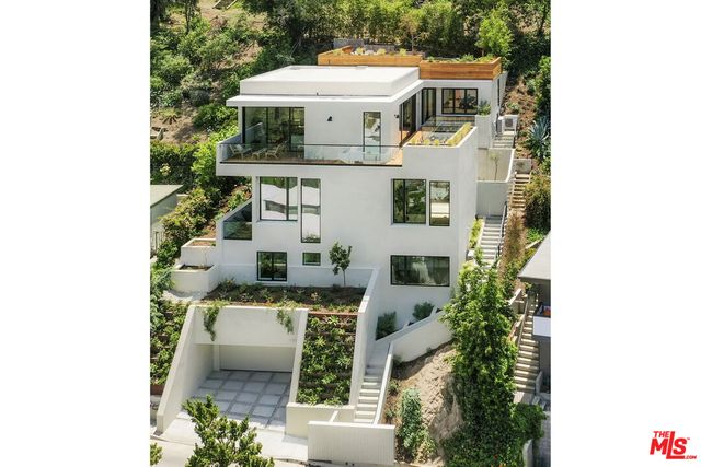 an aerial view of a house with a yard