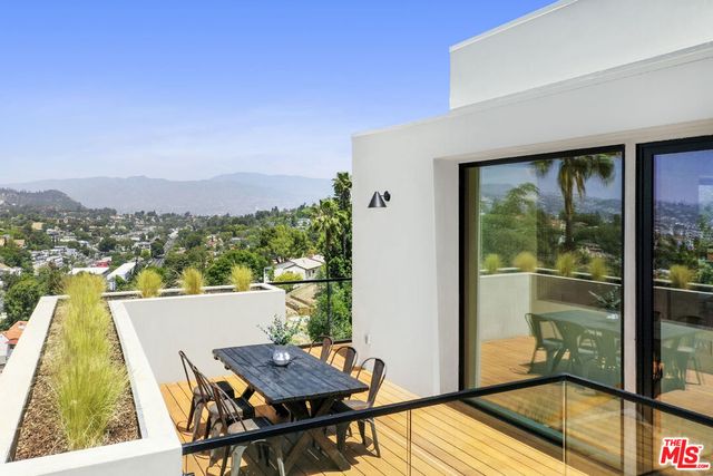 a view of a balcony with table and chairs