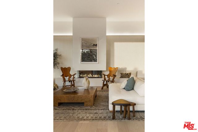 a living room with furniture and floor to ceiling window