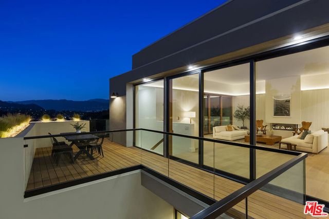 a view of a living room with furniture and floor to ceiling window