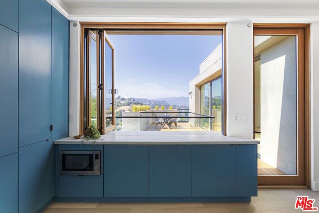 a room with a large window and a flat screen tv