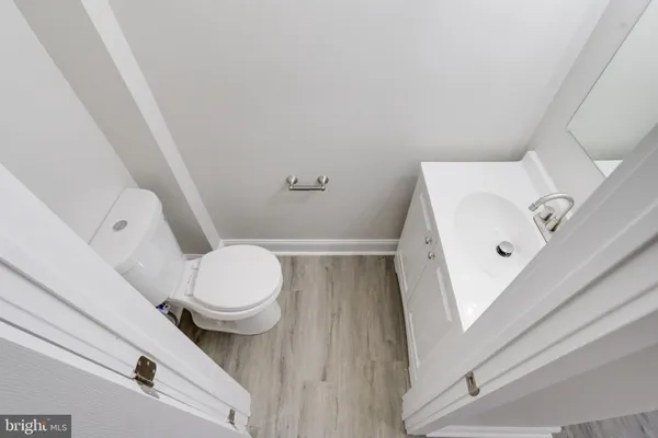 a white toilet sitting next to a white sink