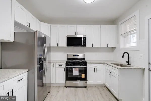 a kitchen with a refrigerator stove and microwave