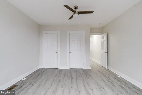 a view of a room with wooden floor and white walls
