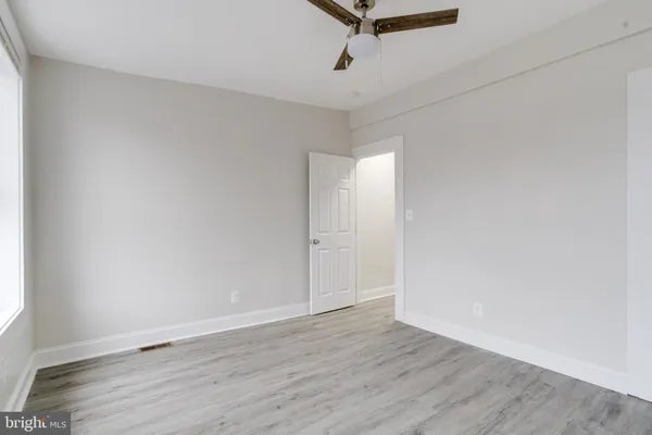 a view of a room with wooden floor and white walls
