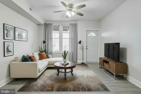 a living room with furniture and a flat screen tv