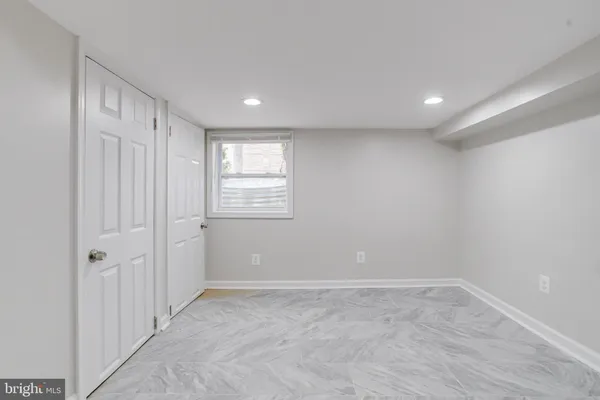 an empty room with windows and closet