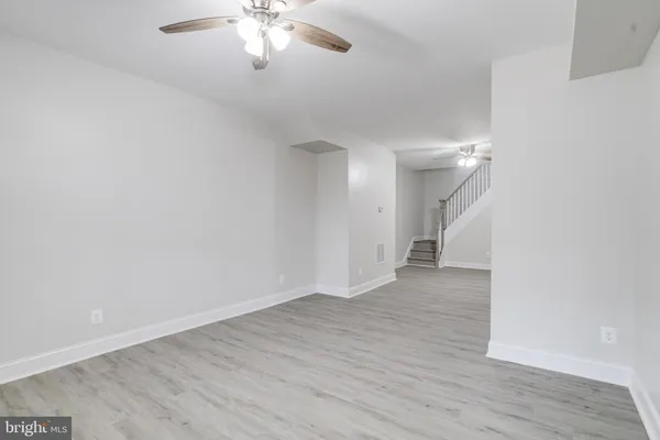a view of an empty room with wooden floor