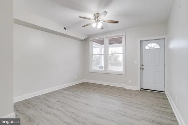 wooden floor in an empty room with a window