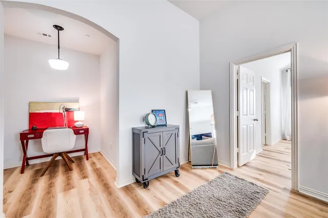 a view of a livingroom with wooden floor and furniture