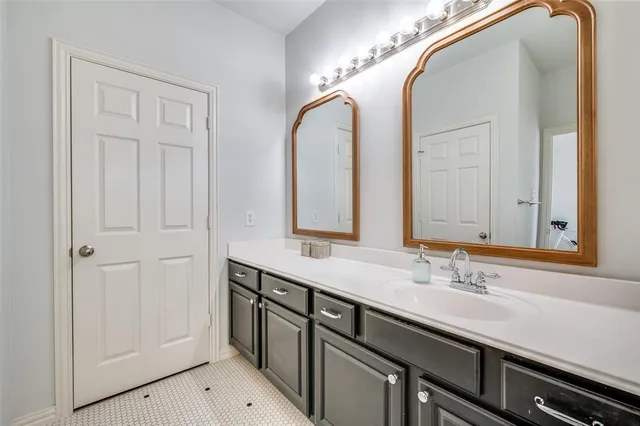 a bathroom with a double vanity sink and a mirror
