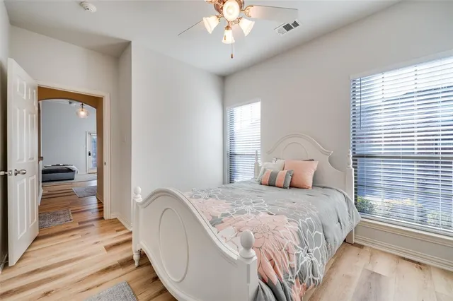 a bedroom with a large bed and a chandelier