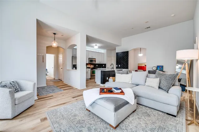 a living room with furniture and kitchen view