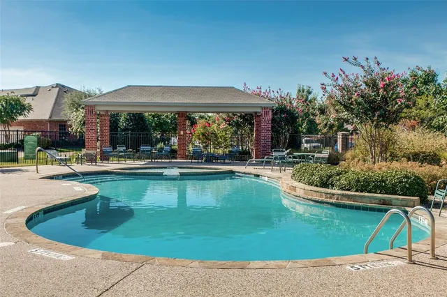 a view of a swimming pool with a patio