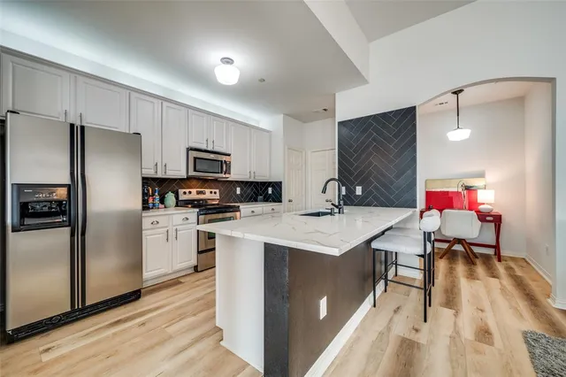 a kitchen with a sink appliances and cabinets