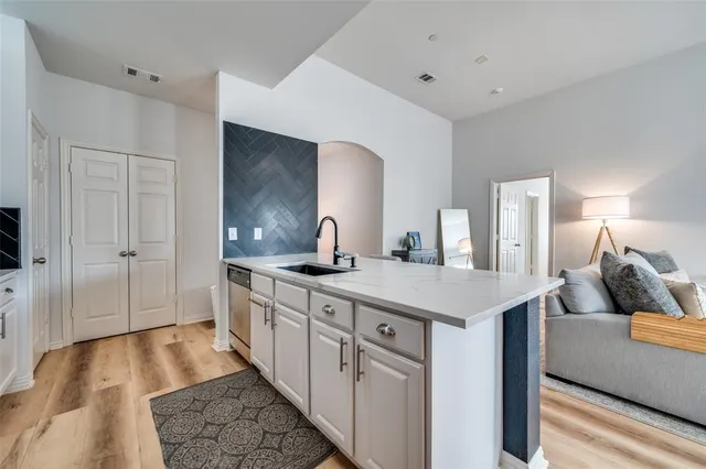a kitchen with a sink and cabinets