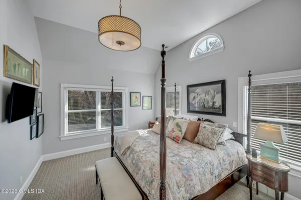 a bedroom with bed and a window