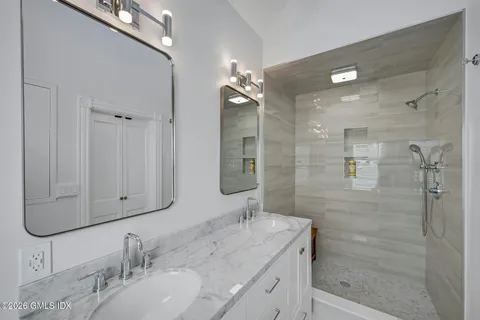 a bathroom with a double vanity sink and a mirror